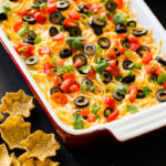 Whether it's football game day in the fall or winter, there's nothing better than wandering over to the food table and finding the best Mexican 7 layer dip. It's the best I've ever had!