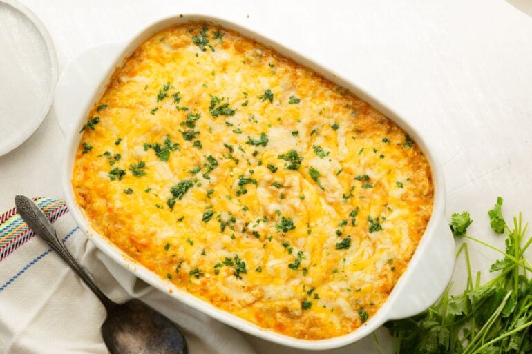 Creamy Mexican chicken and rice casserole topped with melted cheese in a baking dish