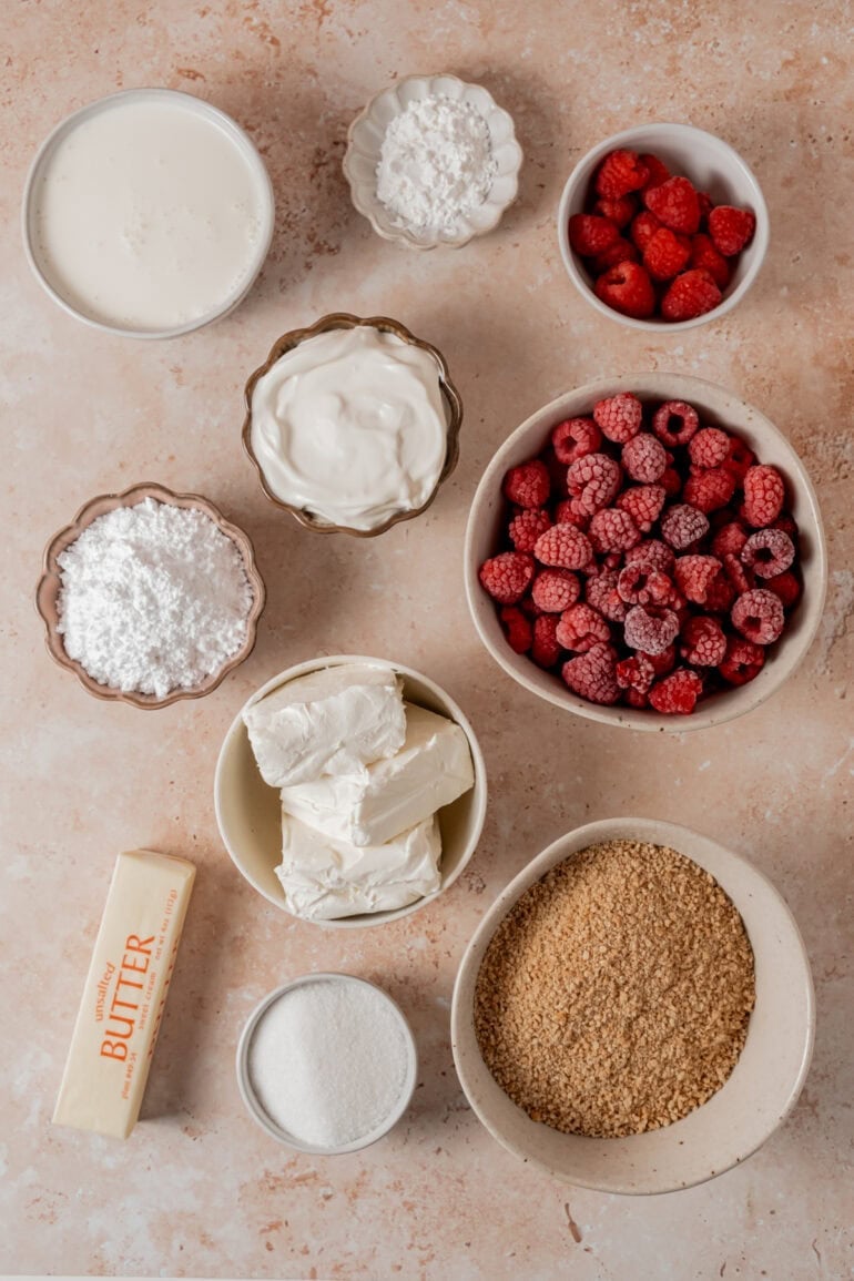 all the ingredients for mini cheesecake with raspberry sauce in separate small bowls