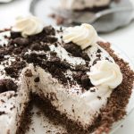 Cut out slice of No Bake Oreo Pie with Chocolate Graham Cracker Crust in a silver pie tray.