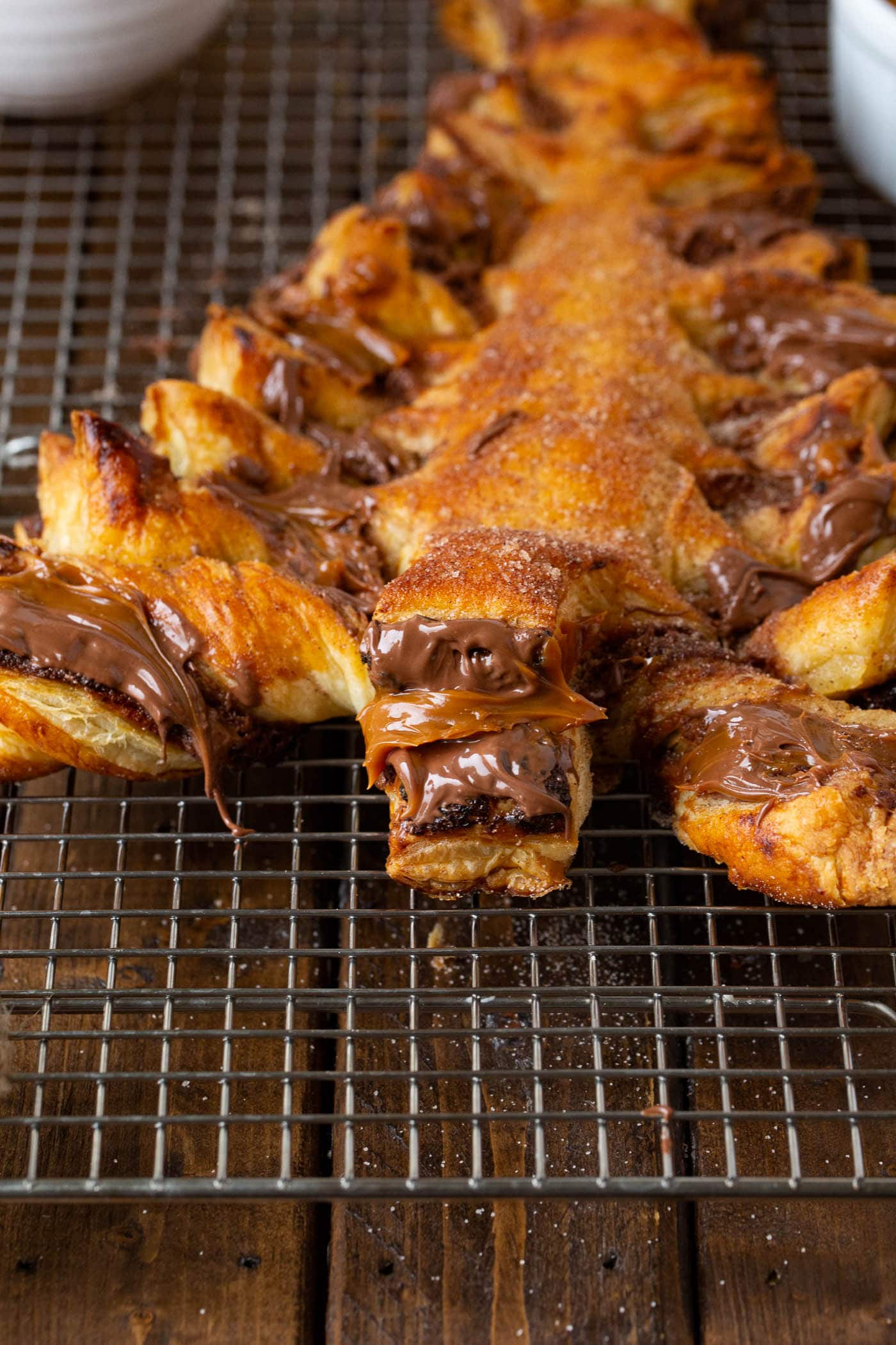 Nutella Dulce de Leche Christmas Tree A photo of perfectly baked golden Nutella dulce de leche Christmas tree sitting on a cooling rack.