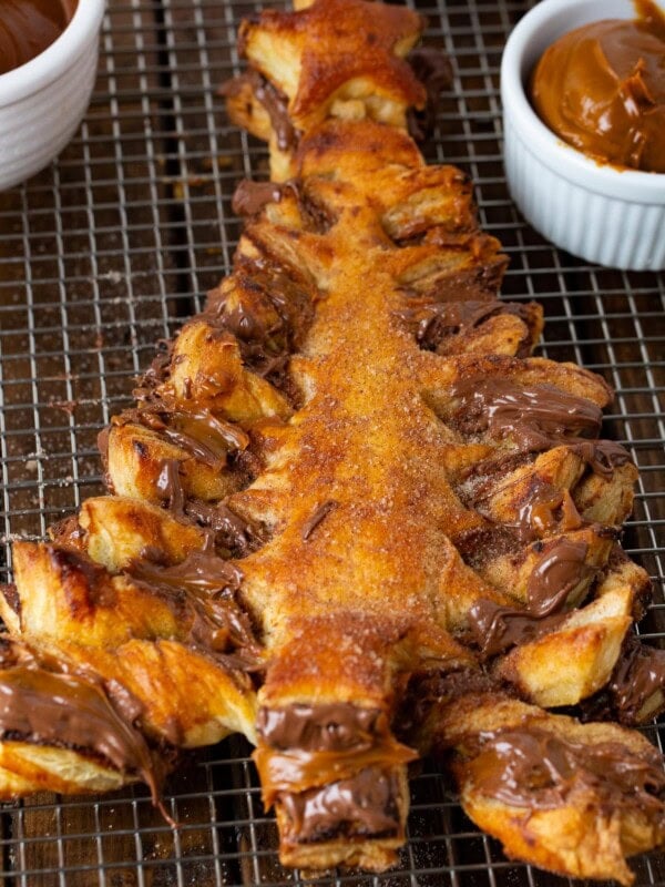 A photo of perfectly baked golden Nutella dulce de leche Christmas tree sitting on a cooling rack.