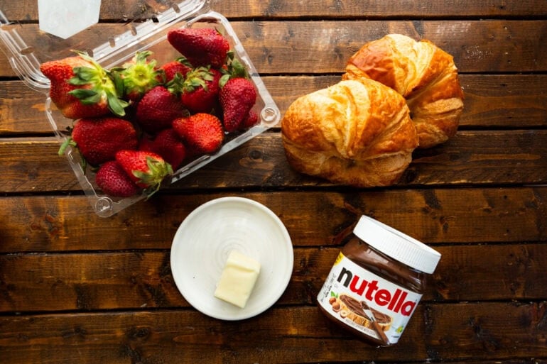 Ingredients for Strawberry Nutella Croissants including strawberries, croissants, butter, and nutella