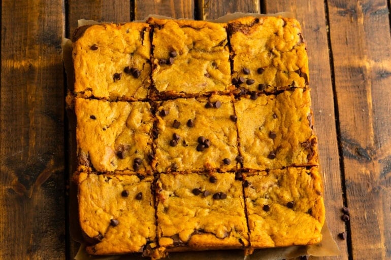 A batch of nutella stuffed brown butter pumpkin bars sliced into nine servings.