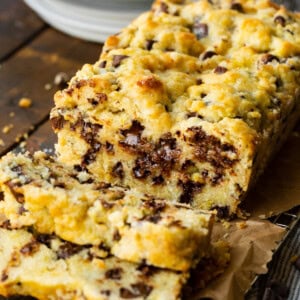 a photo of a loaf of chocolate orange scone bread with a few slices cut off loaded with chocolate chips.
