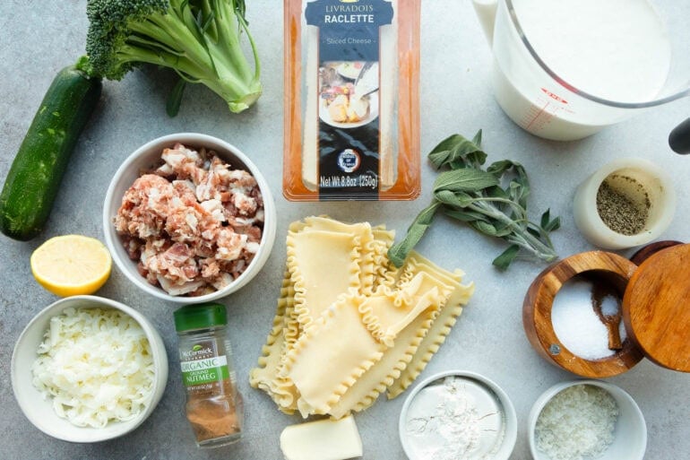 a photo of all the ingredients for pancetta vegetable lasagna with white sauce including fresh sage, pancetta, raclette and seasonings and lasagna noodles