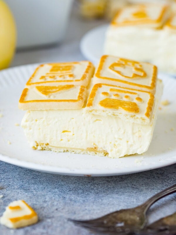 a slice of creamy banana cream pudding with chessman cookies on top