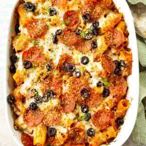 a photo of a 9x13 casserole dish filled with baked pizza pasta casserole