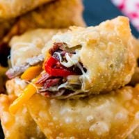Who wouldn't love a crisp, fried egg roll full of meat and cheese? These Philly Cheesesteak Egg Rolls are perfect for football games and parties! ohsweetbasil.com