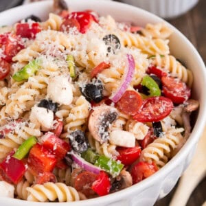 Serve Pizza Pasta Salad at your next barbecue and enjoy the delicious flavors of an Everything Pizza in this veggie, pepperoni, and cheese filled side dish. ohsweetbasil.com