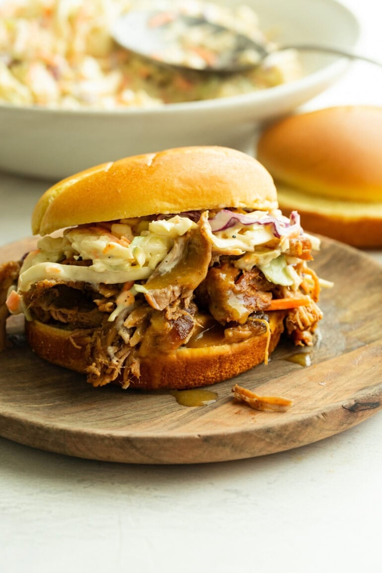 a pulled pork sandwich loaded with juicy shredded pork, coleslaw and a mustard bbq sauce