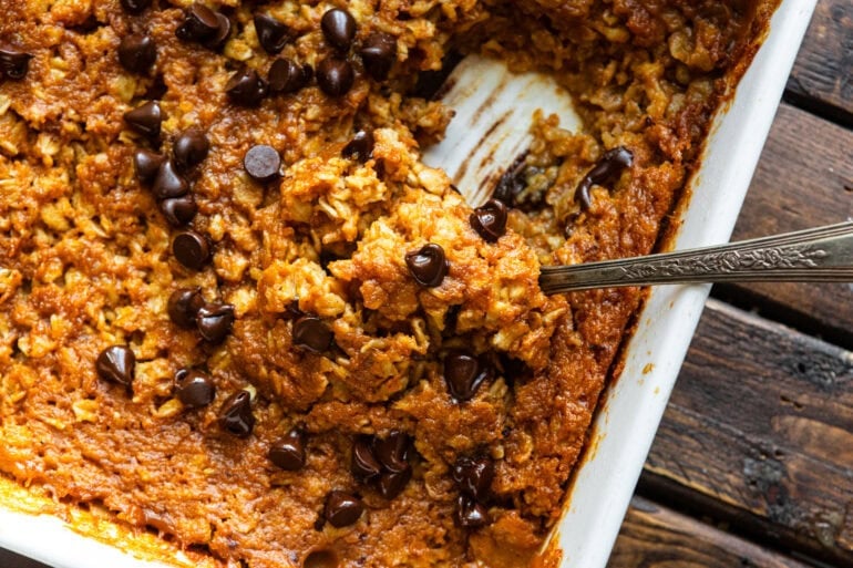 a spoon scooping up a serving of pumpkin chocolate chip baked oatmeal