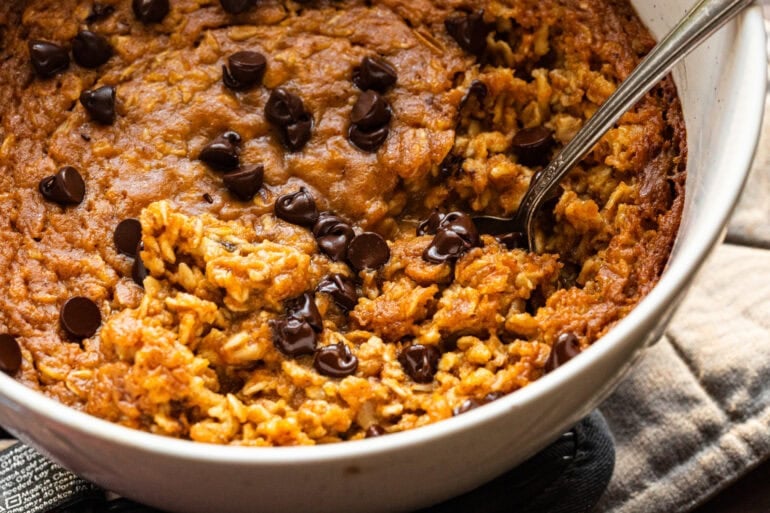 a round cake pan full of baked pumpkin with oatmeal with chocolate chips
