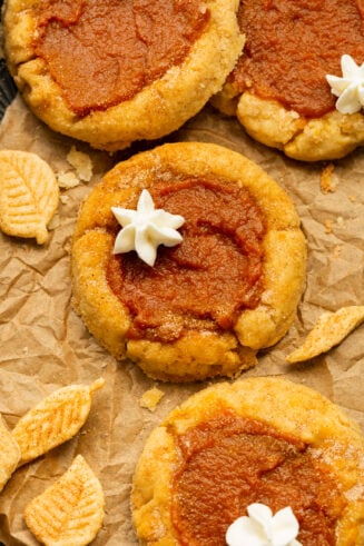 a photo of several pumpkin pie cookies topped with a little dollop of whipped cream.