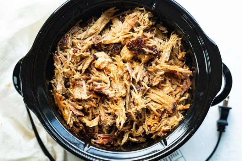 shredded pulled pork in a slow cooker
