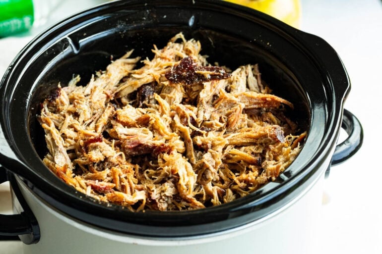 a crockpot full of shredded juicy pulled pork