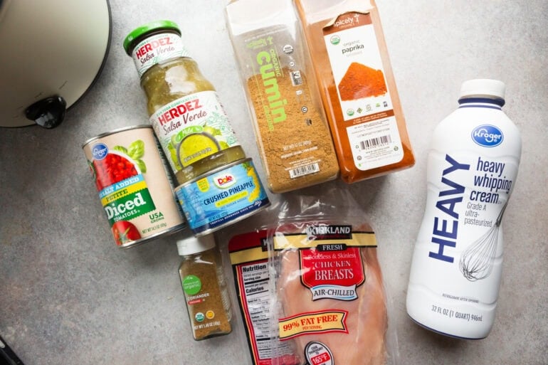 Ingredients for Crock Pot fiesta meal with meat shredded in a saucy pineapple salsa verde sauce