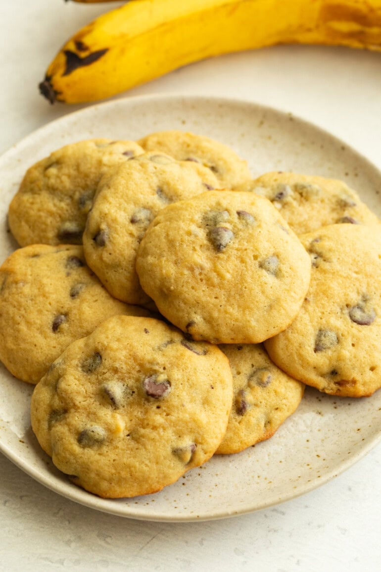 a plate full of fluffy banana cookies loaded with chocolate chips