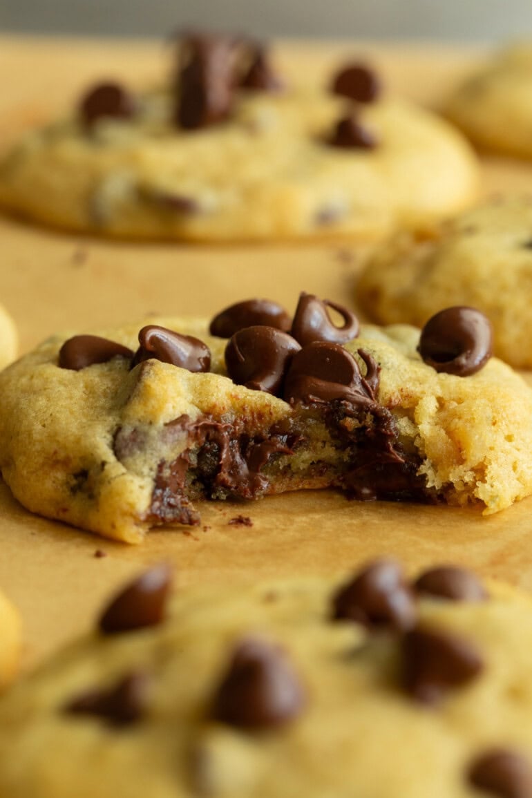 a banana chocolate chip cookie with a bite taken out of it so you can see the cross section of the cookie