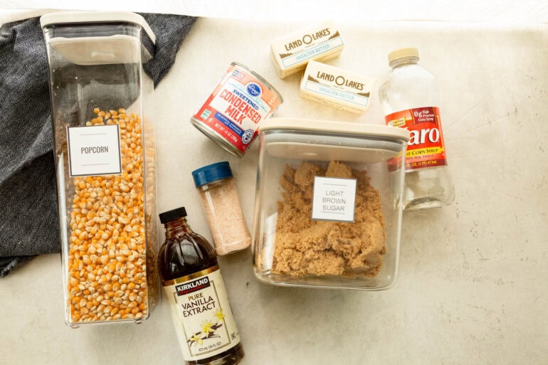 all the ingredients for chewy caramel popcorn sitting on a table