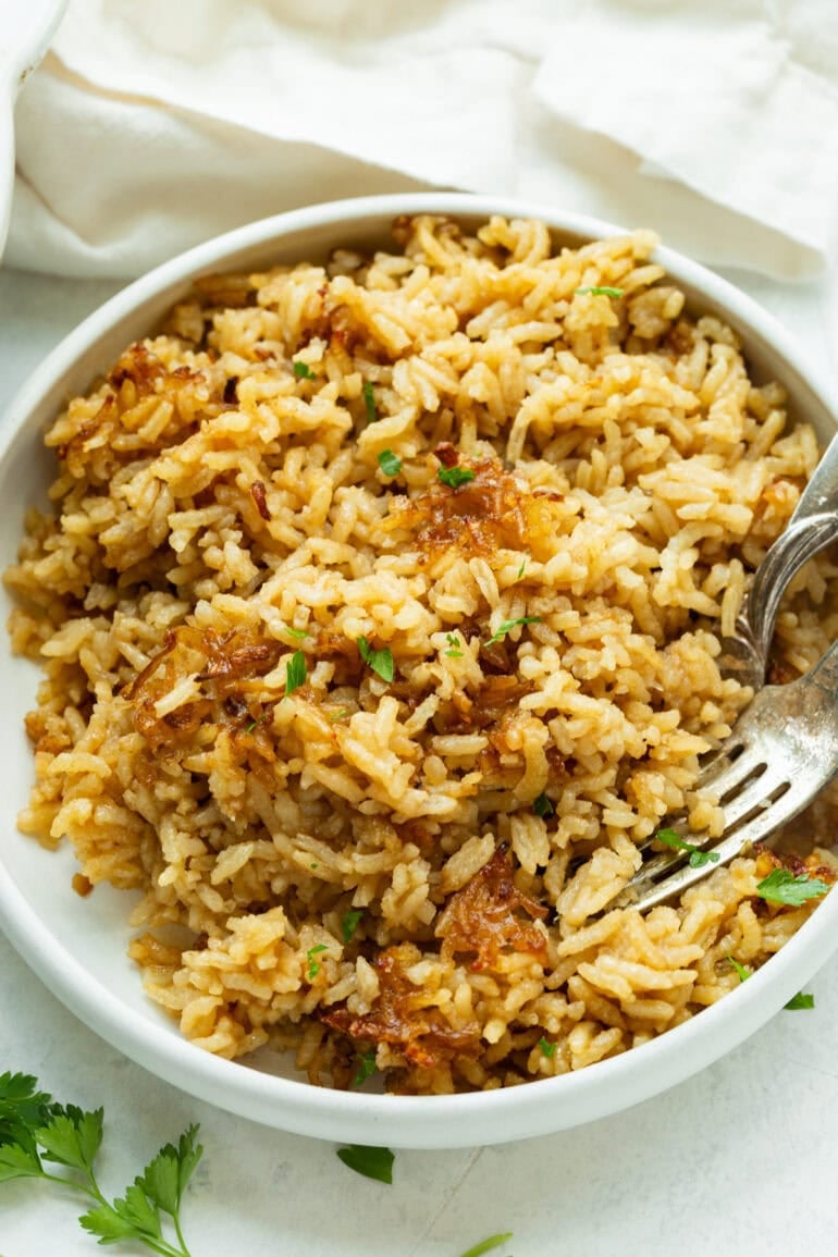 Creamy, comforting rice with a deep savory flavor served in a cozy bowl.