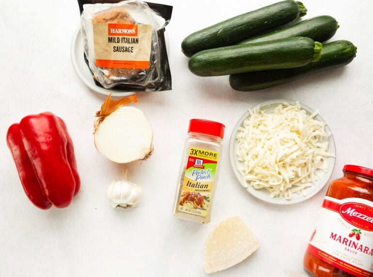 all the ingredients for classic stuffed zucchini boats including zucchinis, red bell pepper, onion, cheese and seasonings