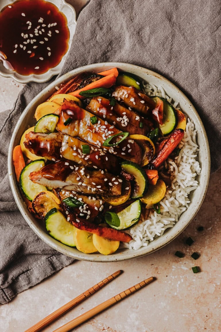 a bowl of teriyaki chicken and vegetables over white rice