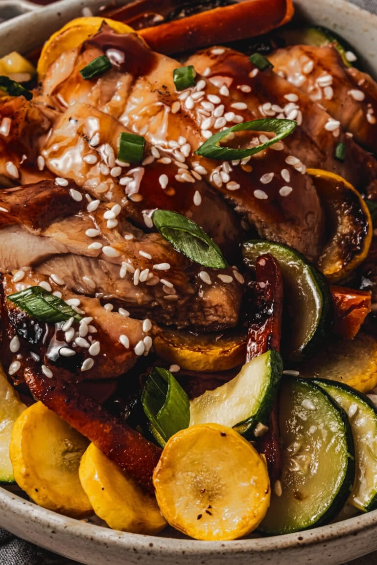 strips of teriyaki chicken mixed with sauteed vegetables and topped with sliced green onions and sesame seeds