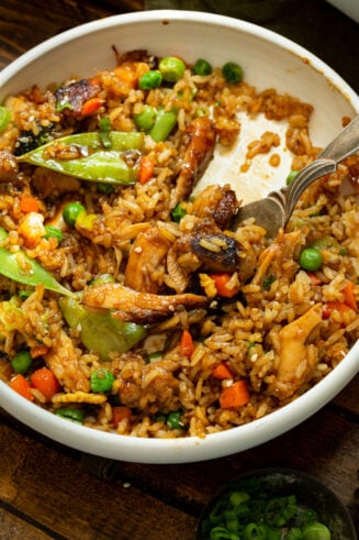 a photo of a large bowl full of teriyaki chicken casserole with a fork sticking in it