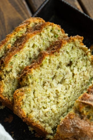 a photo of three slices of zucchini banana bread leaning on each other.