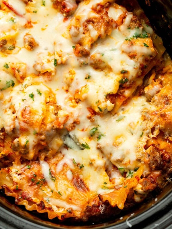 a cooked slow cooker lasagna topped with melted mozzarella cheese