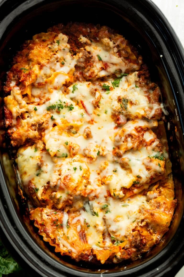 Easy crockpot lasagna with layers of meat sauce, noodles and melted mozzarella cheese