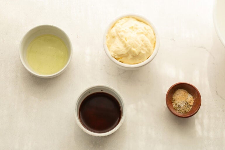 the ingredients for the creamy homemade dressing for a grinder salad in separate small bowls