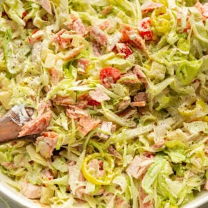 a large white bowl full of a creamy grinder salad