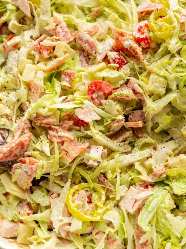 a large white bowl full of a creamy grinder salad