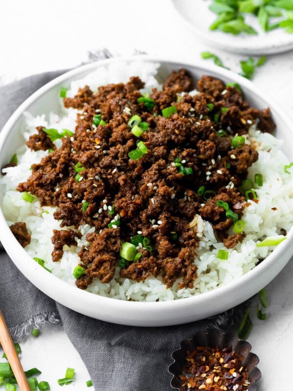a photo of a bowl of steamed white rice topped with korean ground beef and sliced green onions