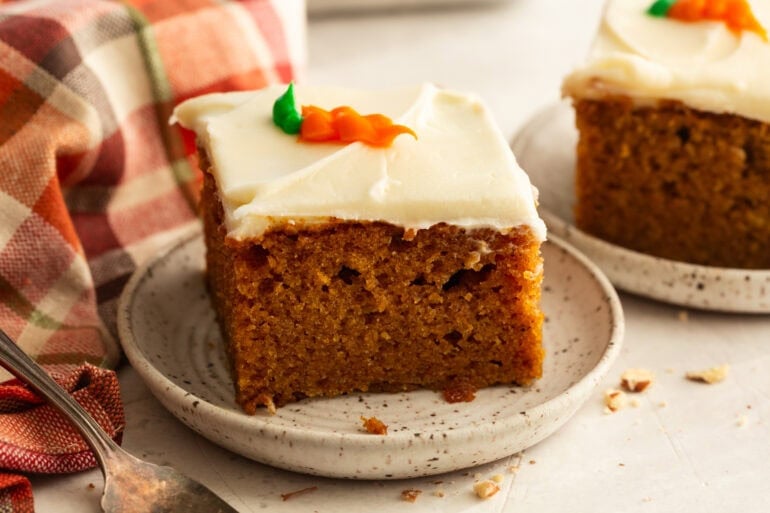 a slice of moist carrot cake with cream cheese frosting