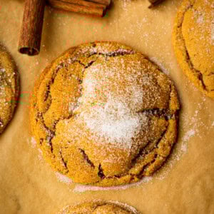 a photo of a soft and chewy molasses cookie topped with sugar and covers in those signature crinkles