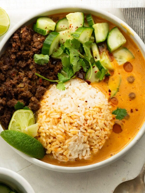 Viral beef broth bowl with crispy ground beef, white rice, creamy coconut curry broth, cucumber, cilantro and lime
