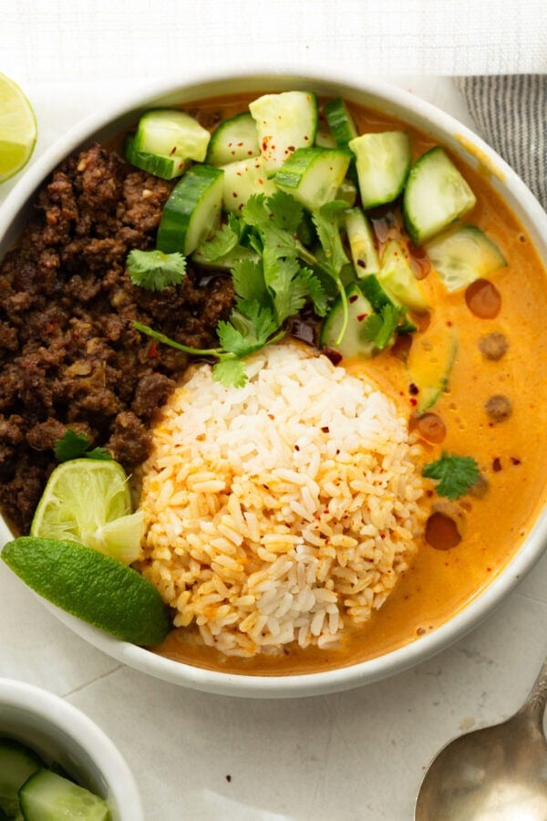 Viral beef broth bowl with crispy ground beef, white rice, creamy coconut curry broth, cucumber, cilantro and lime