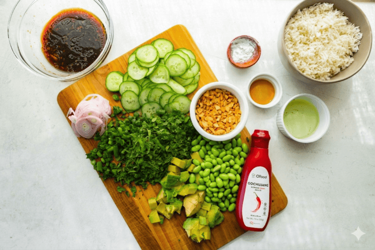 all the ingredients for crispy rice salad including sliced cucumber, avocado, rice, red onions, herbs, edamame, etc