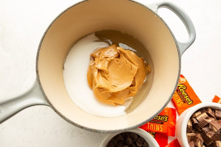 Creamy peanut butter, sugar and Karo syrup being melted in a saucepan