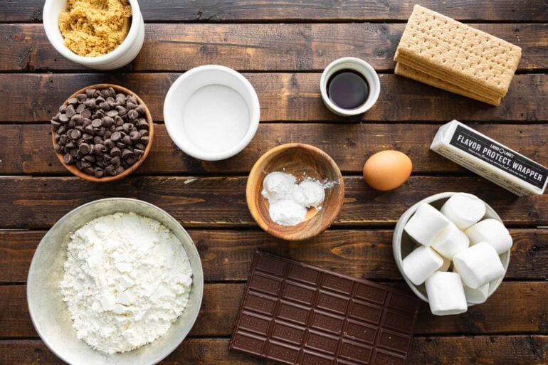 all the ingredients for s'mores cookies in separate small bowls