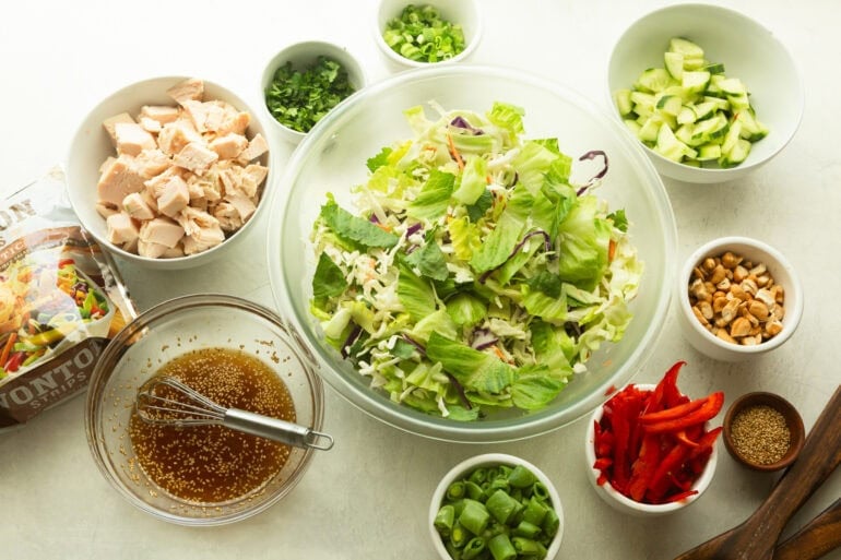 all the ingredients for wonton chinese chicken salad in separate small bowls
